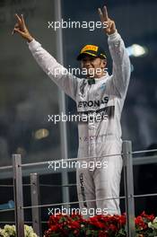 (L to R): Race winner and World Champion Lewis Hamilton (GBR) Mercedes AMG F1 celebrates on the podium. 23.11.2014. Formula 1 World Championship, Rd 19, Abu Dhabi Grand Prix, Yas Marina Circuit, Abu Dhabi, Race Day.