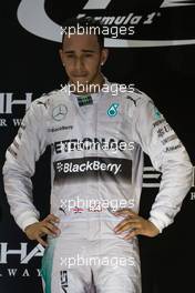 (L to R): Race winner and World Champion Lewis Hamilton (GBR) Mercedes AMG F1 celebrates on the podium. 23.11.2014. Formula 1 World Championship, Rd 19, Abu Dhabi Grand Prix, Yas Marina Circuit, Abu Dhabi, Race Day.
