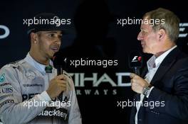 (L to R): Race winner and World Champion Lewis Hamilton (GBR) Mercedes AMG F1 on the podium with Martin Brundle (GBR) Sky Sports Commentator. 23.11.2014. Formula 1 World Championship, Rd 19, Abu Dhabi Grand Prix, Yas Marina Circuit, Abu Dhabi, Race Day.