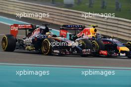 Jean-Eric Vergne (FRA) Scuderia Toro Rosso STR9 and Daniel Ricciardo (AUS) Red Bull Racing RB10 battle for position. 23.11.2014. Formula 1 World Championship, Rd 19, Abu Dhabi Grand Prix, Yas Marina Circuit, Abu Dhabi, Race Day.