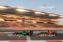 Will Stevens (GBR) Caterham CT05 leads Fernando Alonso (ESP) Ferrari F14-T. 23.11.2014. Formula 1 World Championship, Rd 19, Abu Dhabi Grand Prix, Yas Marina Circuit, Abu Dhabi, Race Day.