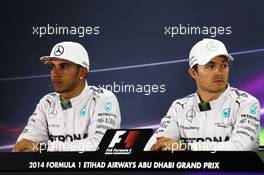 (L to R): Lewis Hamilton (GBR) Mercedes AMG F1 and team mate Nico Rosberg (GER) Mercedes AMG F1 in the FIA Press Conference. 22.11.2014. Formula 1 World Championship, Rd 19, Abu Dhabi Grand Prix, Yas Marina Circuit, Abu Dhabi, Qualifying Day.