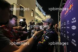 Carlos Sainz Jnr (ESP) Red Bull Racing Test Driver with the media. 25.11.2014. Formula 1 Testing, Day One, Yas Marina Circuit, Abu Dhabi, Tuesday.