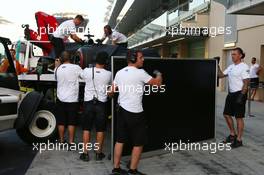 The McLaren MP4-29H of Stoffel Vandoorne (BEL) McLaren Test and Reserve Driver is recovered back to the pits on the back of a truck. 26.11.2014. Formula 1 Testing, Day Two, Yas Marina Circuit, Abu Dhabi, Wednesday.