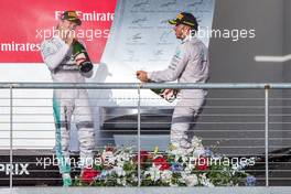 Race winner Lewis Hamilton (GBR) Mercedes AMG F1 (Right) celebrates with team mate Nico Rosberg (GER) Mercedes AMG F1 on the podium. 02.11.2014. Formula 1 World Championship, Rd 17, United States Grand Prix, Austin, Texas, USA, Race Day.