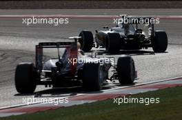 Kevin Magnussen (DEN) McLaren MP4-29 leads Sebastian Vettel (GER) Red Bull Racing RB10. 02.11.2014. Formula 1 World Championship, Rd 17, United States Grand Prix, Austin, Texas, USA, Race Day.