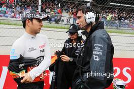 Sergio Perez (MEX) Sahara Force India F1 with Tim Wright (GBR) Sahara Force India F1 Team Race Engineer on the grid. 21.06.2015. Formula 1 World Championship, Rd 8, Austrian Grand Prix, Spielberg, Austria, Race Day.