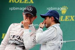 (L to R): race winner Nico Rosberg (GER) Mercedes AMG F1 on the podium with third placed Felipe Massa (BRA) Williams. 21.06.2015. Formula 1 World Championship, Rd 8, Austrian Grand Prix, Spielberg, Austria, Race Day.