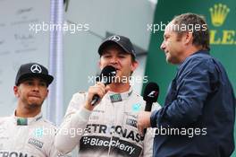 (L to R): Lewis Hamilton (GBR) Mercedes AMG F1 with race winner Nico Rosberg (GER) Mercedes AMG F1 and Gerhard Berger (AUT) on the podium. 21.06.2015. Formula 1 World Championship, Rd 8, Austrian Grand Prix, Spielberg, Austria, Race Day.