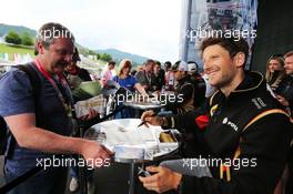 Romain Grosjean (FRA) Lotus F1 Team signs autographs for the fans. 18.06.2015. Formula 1 World Championship, Rd 8, Austrian Grand Prix, Spielberg, Austria, Preparation Day.