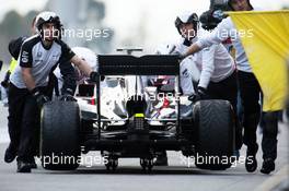 Jenson Button (GBR) McLaren MP4-30 is pushed back down the pit lane by mechanics. 21.02.2015. Formula One Testing, Day Three, Barcelona, Spain.