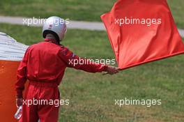 A marshall waves a red flag. 13.05.2015. Formula 1 Testing, Day Two, Barcelona, Spain, Wednesday.