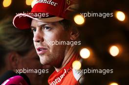 Sebastian Vettel (GER) Ferrari with the media. 18.04.2015. Formula 1 World Championship, Rd 4, Bahrain Grand Prix, Sakhir, Bahrain, Qualifying Day.