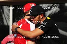 (L to R): Sebastian Vettel (GER) Ferrari with Lewis Hamilton (GBR) Mercedes AMG F1. 16.04.2015. Formula 1 World Championship, Rd 4, Bahrain Grand Prix, Sakhir, Bahrain, Preparation Day.