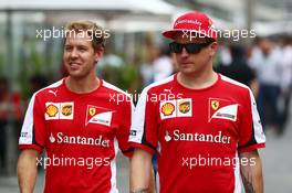 (L to R): Sebastian Vettel (GER) Ferrari with team mate Kimi Raikkonen (FIN) Ferrari. 13.11.2015. Formula 1 World Championship, Rd 18, Brazilian Grand Prix, Sao Paulo, Brazil, Practice Day.