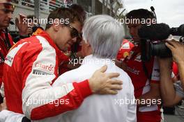 (L to R): Sebastian Vettel (GER) Ferrari with Bernie Ecclestone (GBR) on the grid. 15.11.2015. Formula 1 World Championship, Rd 18, Brazilian Grand Prix, Sao Paulo, Brazil, Race Day.
