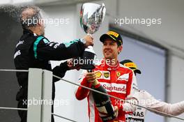 Sebastian Vettel (GER) Ferrari celebrates his third position with Jimmy Waddell (GBR) Mercedes AMG F1 Composite Inspector on the podium. 15.11.2015. Formula 1 World Championship, Rd 18, Brazilian Grand Prix, Sao Paulo, Brazil, Race Day.