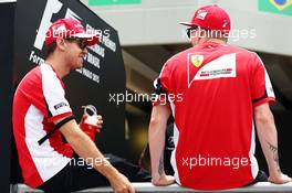 (L to R): Sebastian Vettel (GER) Ferrari with team mate Kimi Raikkonen (FIN) Ferrari on the drivers parade. 15.11.2015. Formula 1 World Championship, Rd 18, Brazilian Grand Prix, Sao Paulo, Brazil, Race Day.