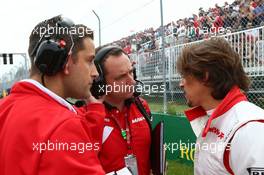Roberto Merhi (ESP) Manor Marussia F1 Team on the grid with Gianluca Pisanello (ITA) Manor Marussia F1 Team Chief Engineer (Centre). 07.06.2015. Formula 1 World Championship, Rd 7, Canadian Grand Prix, Montreal, Canada, Race Day.