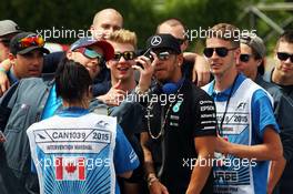 Lewis Hamilton (GBR) Mercedes AMG F1 with course officials on the drivers parade. 07.06.2015. Formula 1 World Championship, Rd 7, Canadian Grand Prix, Montreal, Canada, Race Day.