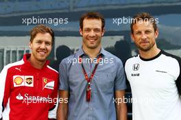 (L to R): Sebastian Vettel (GER) Ferrari with Alex Wurz (AUT) Williams Driver Mentor and Jenson Button (GBR) McLaren. 08.05.2015. Formula 1 World Championship, Rd 5, Spanish Grand Prix, Barcelona, Spain, Practice Day.