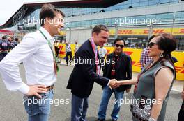 Chalerm Yoovidhya (THA) Red Bull Racing (Right) Co-Owner with his wife on the grid. 05.07.2015. Formula 1 World Championship, Rd 9, British Grand Prix, Silverstone, England, Race Day.