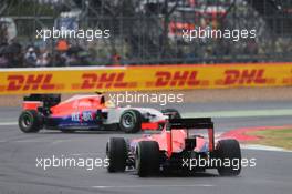Roberto Merhi (ESP) Manor Marussia F1 Team spins in front of team mate Will Stevens (GBR) Manor Marussia F1 Team. 05.07.2015. Formula 1 World Championship, Rd 9, British Grand Prix, Silverstone, England, Race Day.