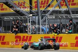 Race winner Lewis Hamilton (GBR) Mercedes AMG F1 W06 celebrates as he passes his team at the end of the race. 05.07.2015. Formula 1 World Championship, Rd 9, British Grand Prix, Silverstone, England, Race Day.