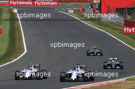 Felipe Massa (BRA) Williams FW37 and team mate Valtteri Bottas (FIN) Williams FW37 battle for position. 05.07.2015. Formula 1 World Championship, Rd 9, British Grand Prix, Silverstone, England, Race Day.