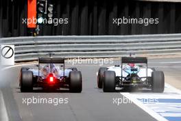 Nico Rosberg (GER) Mercedes AMG F1 W06 and Felipe Massa (BRA) Williams FW37 battle for position leaving the pits. 05.07.2015. Formula 1 World Championship, Rd 9, British Grand Prix, Silverstone, England, Race Day.