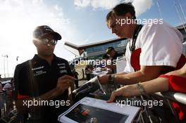 Sergio Perez (MEX) Sahara Force India F1 signs autographs for the fans. 04.07.2015. Formula 1 World Championship, Rd 9, British Grand Prix, Silverstone, England, Qualifying Day.