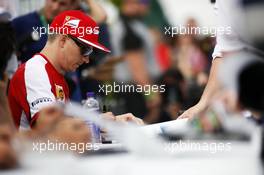 Kimi Raikkonen (FIN) Ferrari signs autographs for the fans. 04.07.2015. Formula 1 World Championship, Rd 9, British Grand Prix, Silverstone, England, Qualifying Day.
