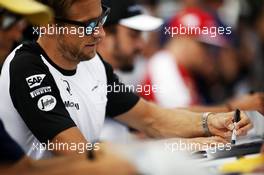 Jenson Button (GBR) McLaren signs autographs for the fans. 04.07.2015. Formula 1 World Championship, Rd 9, British Grand Prix, Silverstone, England, Qualifying Day.