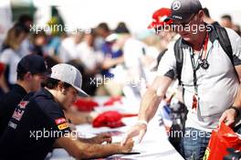 Carlos Sainz Jr (ESP) Scuderia Toro Rosso signs autographs for the fans. 04.07.2015. Formula 1 World Championship, Rd 9, British Grand Prix, Silverstone, England, Qualifying Day.