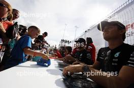 Nico Rosberg (GER) Mercedes AMG F1 signs autographs for the fans. 04.07.2015. Formula 1 World Championship, Rd 9, British Grand Prix, Silverstone, England, Qualifying Day.