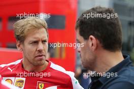 (L to R): Sebastian Vettel (GER) Ferrari with Guillaume Rocquelin (ITA) Red Bull Racing Head of Race Engineering. 26.07.2015. Formula 1 World Championship, Rd 10, Hungarian Grand Prix, Budapest, Hungary, Race Day.