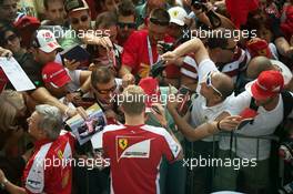 Kimi Raikkonen (FIN) Ferrari signs autographs for the fans. 03.09.2015. Formula 1 World Championship, Rd 12, Italian Grand Prix, Monza, Italy, Preparation Day.
