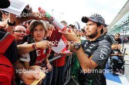 Sergio Perez (MEX) Sahara Force India F1 signs autographs for the fans. 03.09.2015. Formula 1 World Championship, Rd 12, Italian Grand Prix, Monza, Italy, Preparation Day.