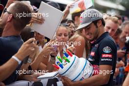 Carlos Sainz Jr (ESP) Scuderia Toro Rosso signs autographs for the fans. 03.09.2015. Formula 1 World Championship, Rd 12, Italian Grand Prix, Monza, Italy, Preparation Day.