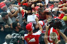 Sebastian Vettel (GER) Ferrari signs autographs for the fans. 03.09.2015. Formula 1 World Championship, Rd 12, Italian Grand Prix, Monza, Italy, Preparation Day.