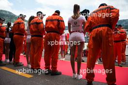 A grid girl and marshals on the drivers parade. 24.05.2015. Formula 1 World Championship, Rd 6, Monaco Grand Prix, Monte Carlo, Monaco, Race Day.