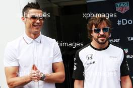 (L to R): Cristiano Ronaldo (POR) Real Madrid Football Player with Fernando Alonso (ESP) McLaren. 24.05.2015. Formula 1 World Championship, Rd 6, Monaco Grand Prix, Monte Carlo, Monaco, Race Day.