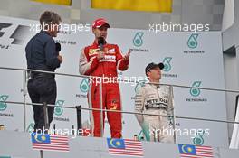 The podium (L to R): Eddie Jordan (IRE) BBC Television Pundit with race winner Sebastian Vettel (GER) Ferrari. 29.03.2015. Formula 1 World Championship, Rd 2, Malaysian Grand Prix, Sepang, Malaysia, Sunday.