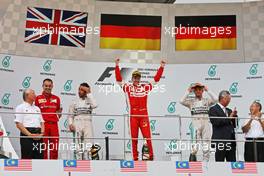 The podium (L to R): Lewis Hamilton (GBR) Mercedes AMG F1, second; Sebastian Vettel (GER) Ferrari, race winner; Nico Rosberg (GER) Mercedes AMG F1, third. 29.03.2015. Formula 1 World Championship, Rd 2, Malaysian Grand Prix, Sepang, Malaysia, Sunday.