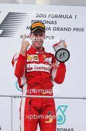Race winner Sebastian Vettel (GER) Ferrari celebrates on the podium. 29.03.2015. Formula 1 World Championship, Rd 2, Malaysian Grand Prix, Sepang, Malaysia, Sunday.