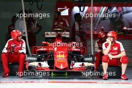 Ferrari mechanics sit by the Ferrari SF15-T of Kimi Raikkonen (FIN) Ferrari. 28.03.2015. Formula 1 World Championship, Rd 2, Malaysian Grand Prix, Sepang, Malaysia, Saturday.
