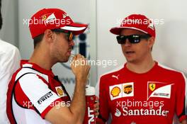 (L to R): Sebastian Vettel (GER) Ferrari with Kimi Raikkonen (FIN) Ferrari on the drivers parade. 29.03.2015. Formula 1 World Championship, Rd 2, Malaysian Grand Prix, Sepang, Malaysia, Sunday.