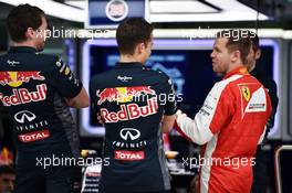 Sebastian Vettel (GER) Ferrari visits the Red Bull Racing pit garage. 26.03.2015. Formula 1 World Championship, Rd 2, Malaysian Grand Prix, Sepang, Malaysia, Thursday.