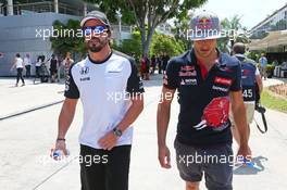 (L to R): Fernando Alonso (ESP) McLaren with Carlos Sainz Jr (ESP) Scuderia Toro Rosso. 26.03.2015. Formula 1 World Championship, Rd 2, Malaysian Grand Prix, Sepang, Malaysia, Thursday.