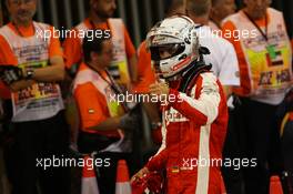 Sebastian Vettel (GER) Ferrari in parc ferme. 29.11.2015. Formula 1 World Championship, Rd 19, Abu Dhabi Grand Prix, Yas Marina Circuit, Abu Dhabi, Race Day.